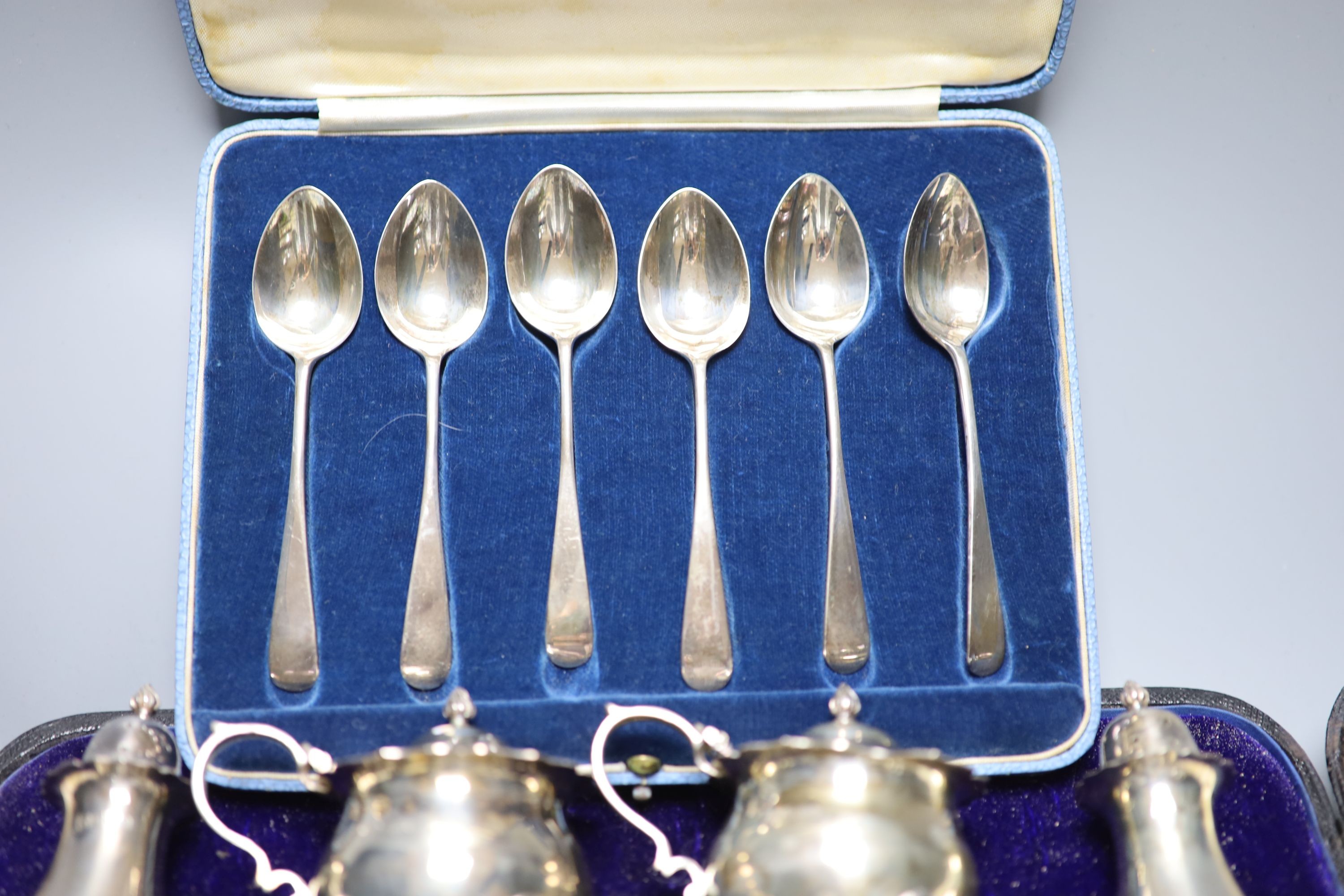 A cased set set of six 'British Hallmark' teaspoons and a cased part silver condiment set.